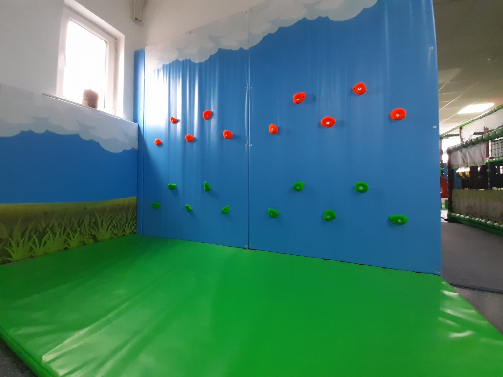 A picture of a climbing wall at the soft toy area for children